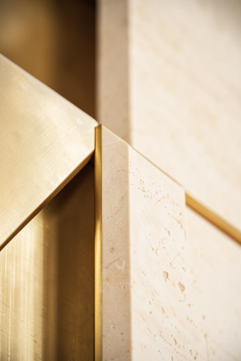 Brushed gold and stone architectural detail